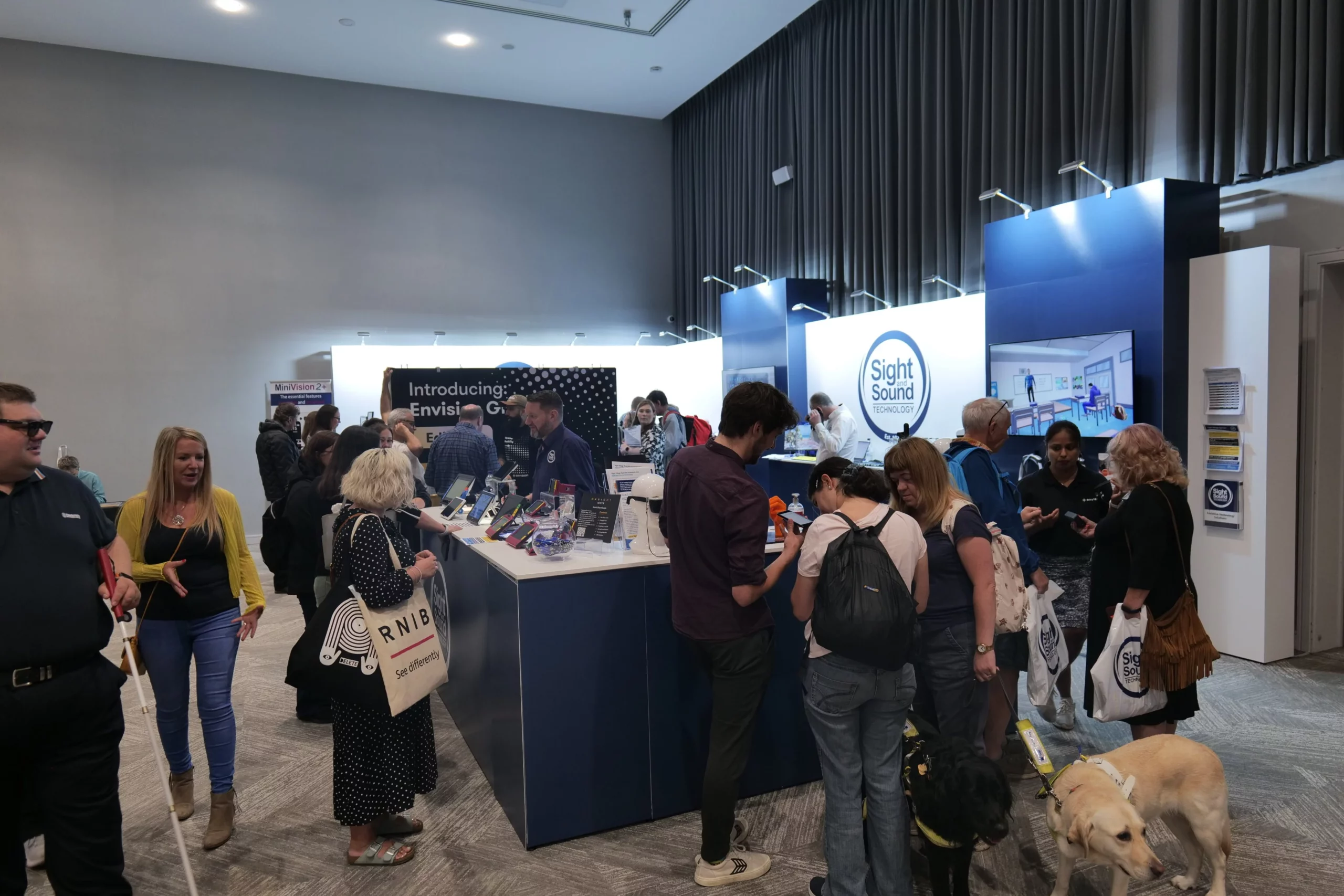 The Sight and Sound exhibition stand at Sight Village Central 2023. Demonstrations of the Envision Glasses, Hable One and HIMS Senseplayer taking place.